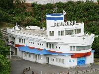 全体が白い船の形をしており、煙突部分には水色の2重線が入っている木江ふれあい郷土資料館の写真